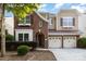 Charming two-story home featuring a two-car garage, brick facade, and meticulously landscaped front yard at 9429 Ridgeforest Dr, Charlotte, NC 28277