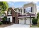 Charming two-story home featuring a two-car garage, brick facade, and meticulously landscaped front yard with basketball hoop at 9429 Ridgeforest Dr, Charlotte, NC 28277