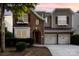 Charming two-story home featuring a two-car garage, brick facade, and meticulously landscaped front yard at 9429 Ridgeforest Dr, Charlotte, NC 28277