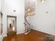 A grand foyer with hardwood floors, soaring ceilings, a gracefully curved staircase, and ample natural light at 9429 Ridgeforest Dr, Charlotte, NC 28277