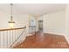 Upstairs landing with wood floors, stairway and chandelier at 9429 Ridgeforest Dr, Charlotte, NC 28277