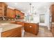 Spacious kitchen with wooden cabinets, an island, modern appliances, and tiled floors at 9429 Ridgeforest Dr, Charlotte, NC 28277