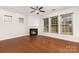 Inviting living room features hardwood floors, a classic fireplace, and large windows offering plenty of natural light at 9429 Ridgeforest Dr, Charlotte, NC 28277