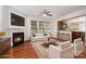 Cozy living room with fireplace, ceiling fan, and views to kitchen through open layout at 9429 Ridgeforest Dr, Charlotte, NC 28277