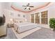 Bright main bedroom features a ceiling fan, decorative windows, and a large window for natural light at 9429 Ridgeforest Dr, Charlotte, NC 28277
