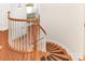 Gorgeous winding staircase with hardwood steps and white wood banister at 9429 Ridgeforest Dr, Charlotte, NC 28277
