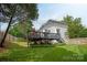 Beautifully landscaped backyard and patio with a nice lawn and tall trees at 10924 Owl Nest Ln, Charlotte, NC 28277