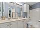Blue bathroom featuring a double sink vanity, bath tub, and ample storage at 10924 Owl Nest Ln, Charlotte, NC 28277