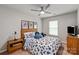 Comfortable bedroom with a bed featuring a blue and white floral pattern and ceiling fan at 10924 Owl Nest Ln, Charlotte, NC 28277