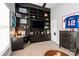Well-lit bedroom with a built-in bookshelf, a desk, and a framed jersey on the wall at 10924 Owl Nest Ln, Charlotte, NC 28277
