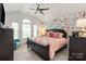 Charming bedroom features vaulted ceilings, floral wallpaper and a dark wood bedframe at 10924 Owl Nest Ln, Charlotte, NC 28277