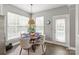 Bright breakfast nook featuring a round table, large windows, and backyard access at 10924 Owl Nest Ln, Charlotte, NC 28277