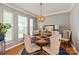 Cozy dining area with a round table, stylish chairs, and natural light from surrounding windows at 10924 Owl Nest Ln, Charlotte, NC 28277