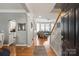 Bright entryway with hardwood floors, elegant columns, and staircase, leading into the living space at 10924 Owl Nest Ln, Charlotte, NC 28277