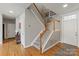 Entryway featuring hardwood floors, a staircase, and neutral gray walls, blending comfort with style at 10924 Owl Nest Ln, Charlotte, NC 28277