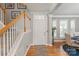 Inviting foyer featuring hardwood floors, a staircase, and soft gray walls, offering a warm welcome at 10924 Owl Nest Ln, Charlotte, NC 28277