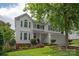 Charming two-story home boasts a manicured lawn and a classic white facade, creating a welcoming curb appeal at 10924 Owl Nest Ln, Charlotte, NC 28277