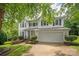 This inviting two-story home features a well-maintained lawn and an attached two-car garage at 10924 Owl Nest Ln, Charlotte, NC 28277