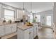 Kitchen with a view of breakfast area featuring white cabinets, stainless appliances, and island at 10924 Owl Nest Ln, Charlotte, NC 28277