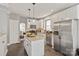 Kitchen featuring stainless steel appliances, white cabinetry, and a granite island at 10924 Owl Nest Ln, Charlotte, NC 28277