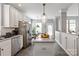 Kitchen featuring stainless appliances, white cabinets, granite countertops, and access to breakfast nook at 10924 Owl Nest Ln, Charlotte, NC 28277