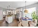 Well-lit eat-in kitchen features stainless steel appliances and white cabinetry at 10924 Owl Nest Ln, Charlotte, NC 28277