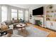 Spacious living room with a fireplace, built-in shelves, and large windows for plenty of natural light at 10924 Owl Nest Ln, Charlotte, NC 28277