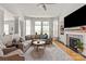 Bright living room with a fireplace, built-in shelves, and expansive windows for abundant natural light at 10924 Owl Nest Ln, Charlotte, NC 28277