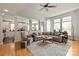 Open-concept living room with hardwood floors, stylish furnishings, and seamless flow to the kitchen at 10924 Owl Nest Ln, Charlotte, NC 28277