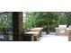 Covered outdoor kitchen with grill and natural stone counters and accents at 10924 Owl Nest Ln, Charlotte, NC 28277