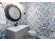 Charming powder room with stylish wallpaper, vanity and round mirror at 10924 Owl Nest Ln, Charlotte, NC 28277