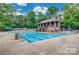 Community pool area featuring a large in-ground swimming pool and plenty of lounge chairs at 10924 Owl Nest Ln, Charlotte, NC 28277