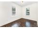 Sunlit bedroom with hardwood floors, offering a bright and airy space with two windows at 1112 Concord Ave, Monroe, NC 28110