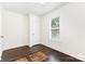 Bright bedroom featuring hardwood floors, white walls, and natural light from a window at 1112 Concord Ave, Monroe, NC 28110