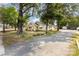 Charming home with mature trees, landscaping, and a gravel driveway at 1112 Concord Ave, Monroe, NC 28110