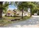 Home with mature trees, landscaping, and gravel driveway at 1112 Concord Ave, Monroe, NC 28110