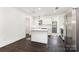 Modern kitchen with sleek countertops, white cabinetry, an island, and stainless steel appliances at 1112 Concord Ave, Monroe, NC 28110
