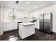 Modern kitchen with an island, stainless steel appliances, and a seamless flow to the living room at 1112 Concord Ave, Monroe, NC 28110