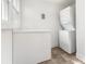 Functional laundry area with a stacked washer and dryer and a white storage bench at 1112 Concord Ave, Monroe, NC 28110