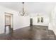Spacious living area featuring new light fixtures, hardwood floors, and an open floor plan at 1112 Concord Ave, Monroe, NC 28110