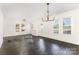 Bright living space featuring refinished wood floors, large windows, and modern light fixtures at 1112 Concord Ave, Monroe, NC 28110