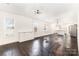 Open concept living space features refinished floors, white walls, and modern light fixtures at 1112 Concord Ave, Monroe, NC 28110