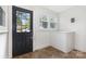 Bright mudroom features a black door with glass inserts, large window, and a functional white storage bench at 1112 Concord Ave, Monroe, NC 28110