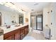 Bathroom featuring double sinks, tiled shower, and neutral decor at 1126 Roderick Dr, Fort Mill, SC 29708