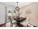 Bright dining room features a stylish light fixture, modern table, and access to outdoor space at 1126 Roderick Dr, Fort Mill, SC 29708