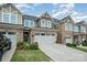 Charming townhouse featuring a stone facade, two-car garage, and well-maintained landscaping at 1126 Roderick Dr, Fort Mill, SC 29708