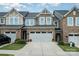 Charming townhouse featuring a stone facade, two-car garage, and well-maintained landscaping at 1126 Roderick Dr, Fort Mill, SC 29708
