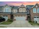 Charming townhouse featuring a stone facade, two-car garage, and well-maintained landscaping at 1126 Roderick Dr, Fort Mill, SC 29708