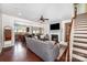 Inviting living room features a fireplace, hardwood floors, ceiling fan, and staircase at 1126 Roderick Dr, Fort Mill, SC 29708