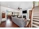 Inviting living room features a fireplace, hardwood floors, ceiling fan, and staircase at 1126 Roderick Dr, Fort Mill, SC 29708